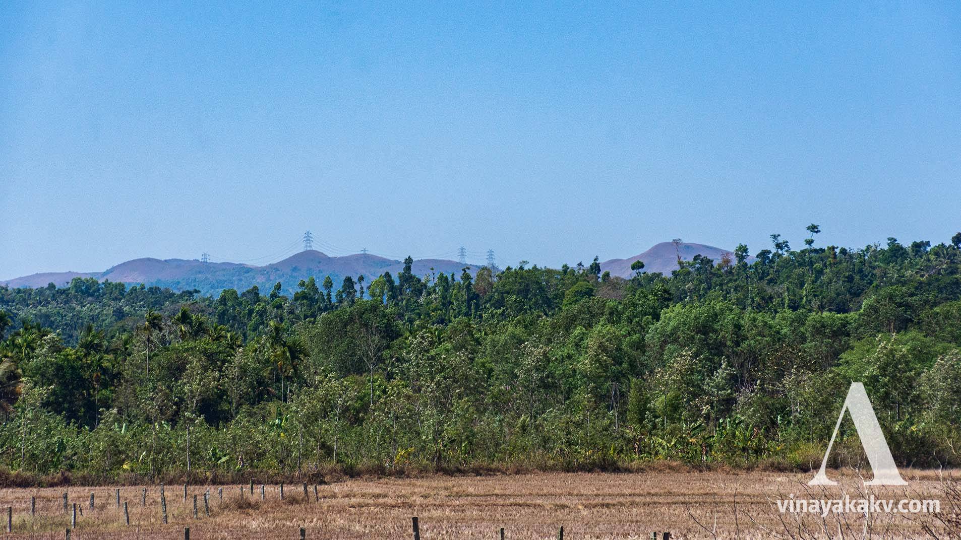 A mountain carrying power line at its top. Notice the land is not as mountainous compared to previous pictures.
