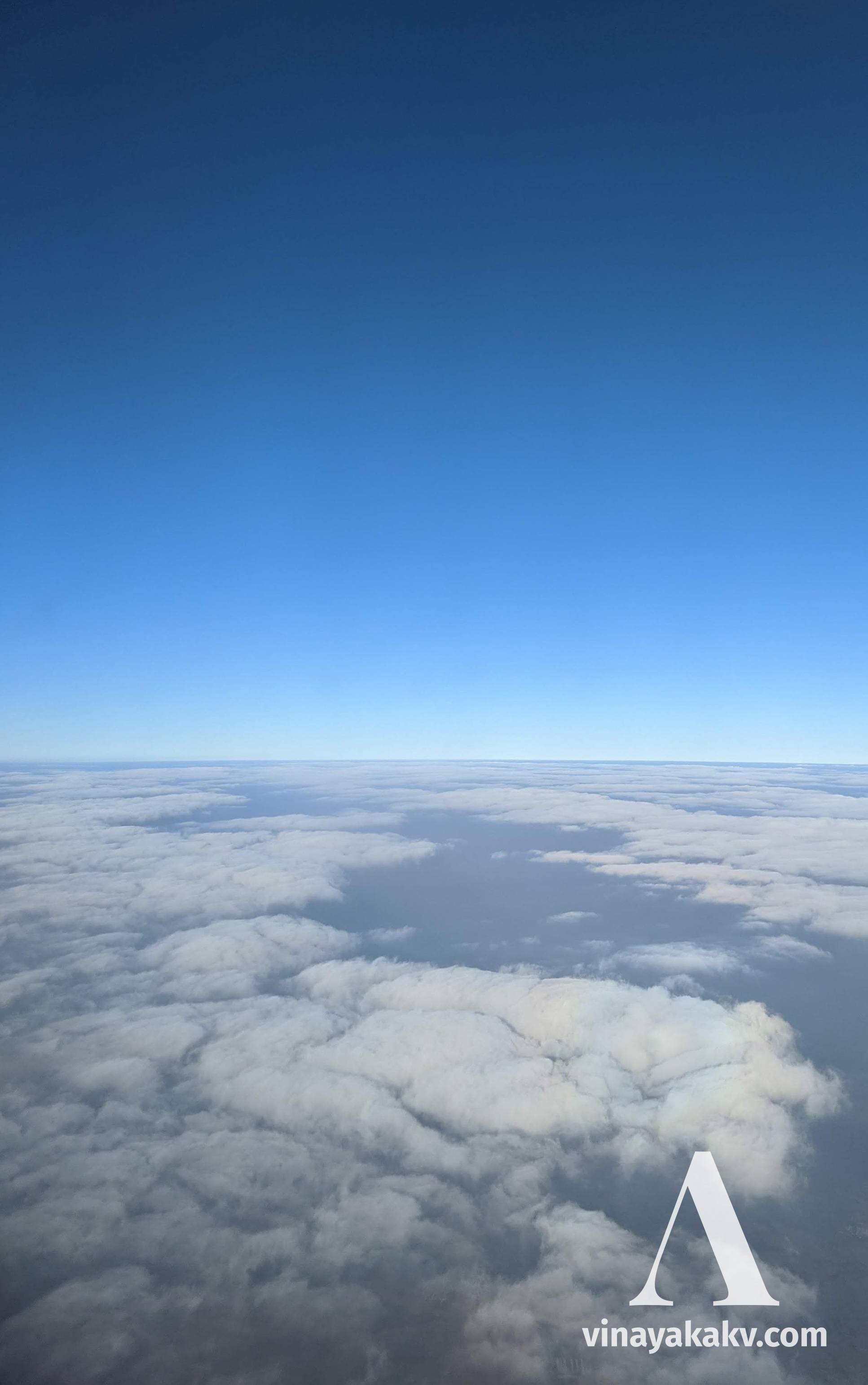 The haze layer seen below during an airplane flight. Whenever there is no cloud, you can see the layer clearly. It is very hard to observe the things below the layer. Above the layer is the clear sky.