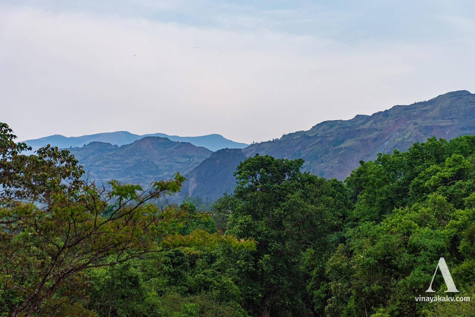 The mountains that were mined. We still see KIOCL facilites sych as power line and a bridge.