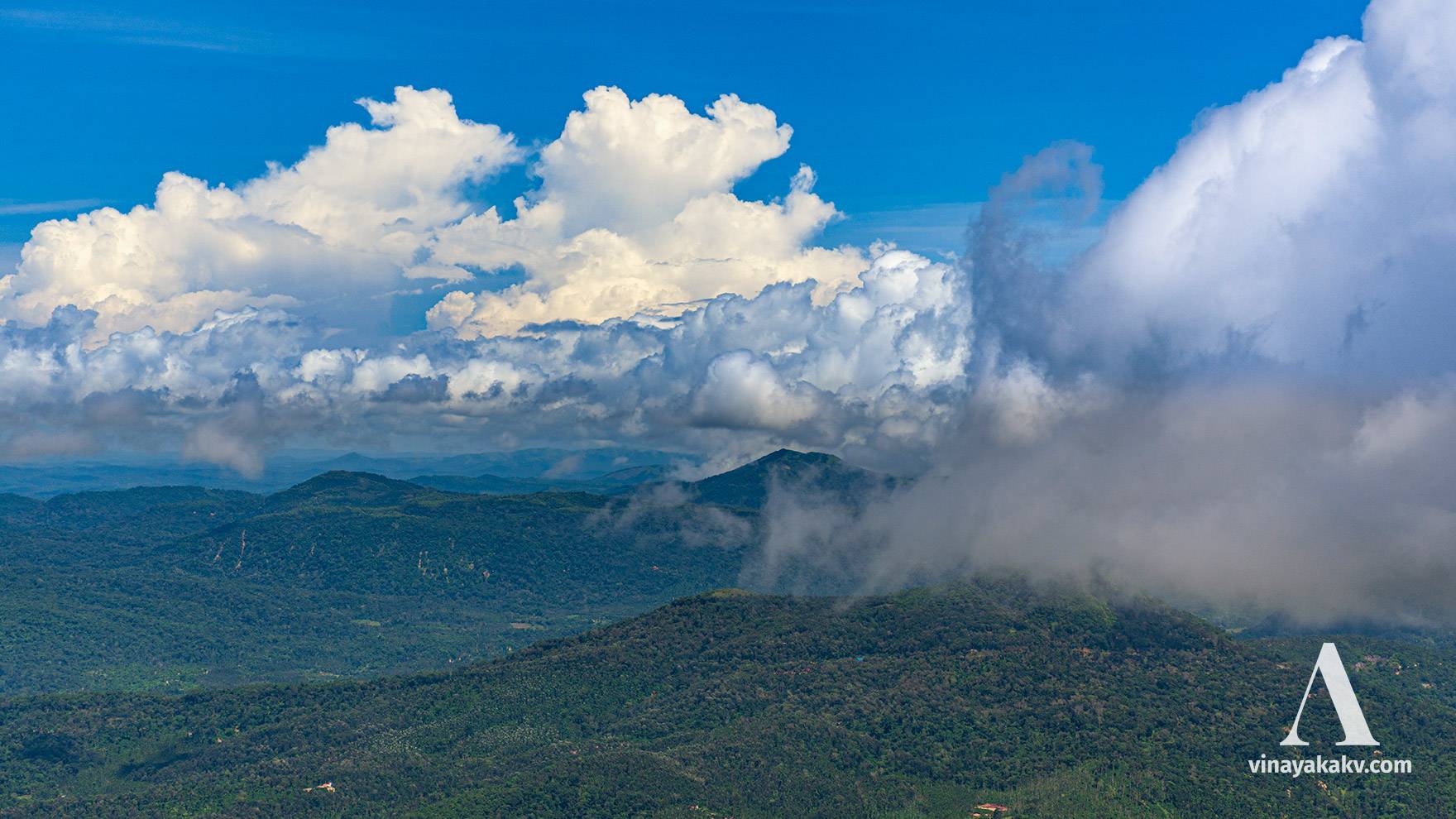 During the monsoon-break, the air is free of haze. But the presence of clouds makes it hard to see some mountains.