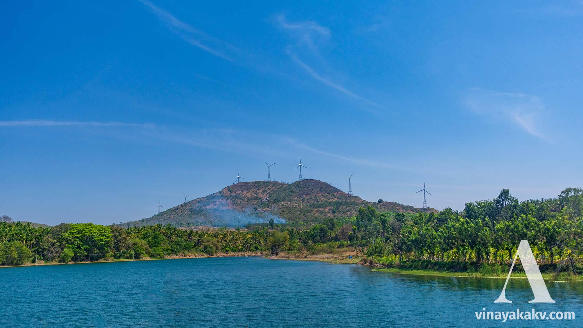 Wind energy towers situated atop a hillock near the plains of _Belur_.